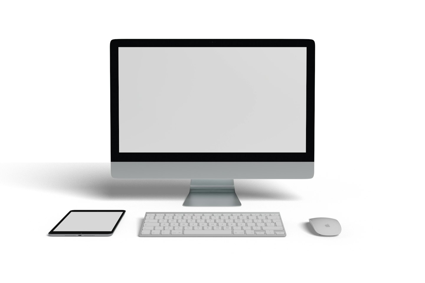 Modern desktop computer with monitor, keyboard, mouse, and tablet on white desk.
